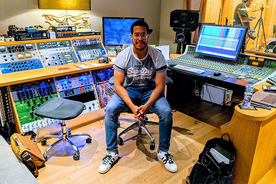 Children's music teacher in a recording studio at Besharp Music School, Adelaide, instructing students in music production.