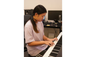 Gallery - Gallery Music School. teenage girl playing the piano in a music school, showcasing her skill and passion for music as she gracefully performs on the piano keys under the guidance of her music teacher, demonstrating her dedication and talent in pursuing musical excellence. Adelaide piano instruction, piano lessons Adelaide, Adelaide piano classes, Adelaide piano tutoring, Linden Park SA piano instruction.