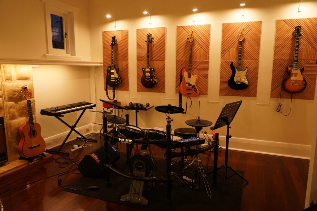Drum lessons room with electric guitars, bass and keyboard at BeSharp Music School Adelaide