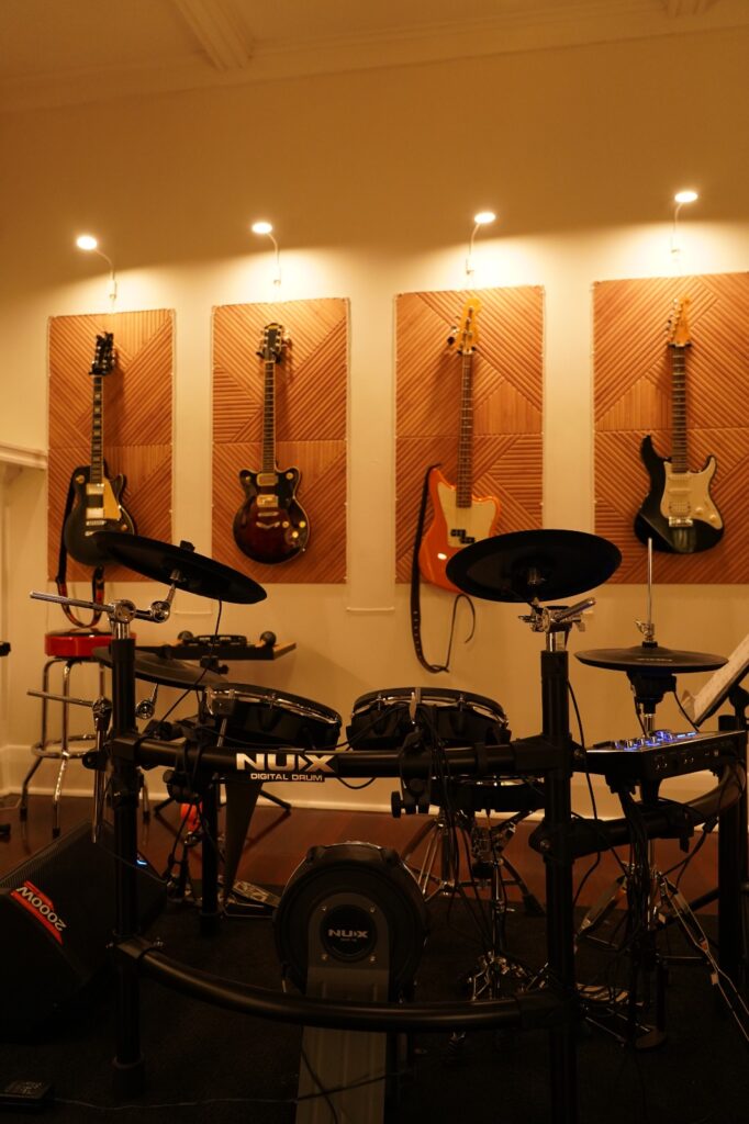 Electronic drum kit with guitars in the BeSharp drum lessons studio in Adelaide