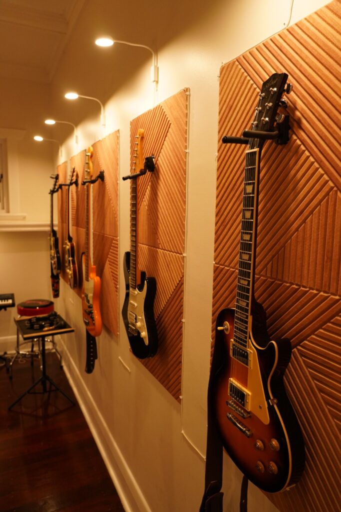 Electric guitars and bass displayed on the studio wall at BeSharp Music School Adelaide