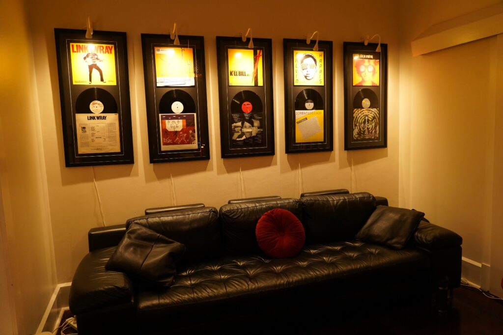Student lounge with sofa and framed music memorabilia at BeSharp Music School Tusmore