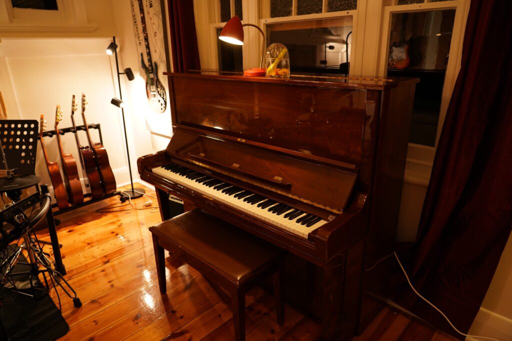 Piano lessons room with upright piano at BeSharp Music School Adelaide